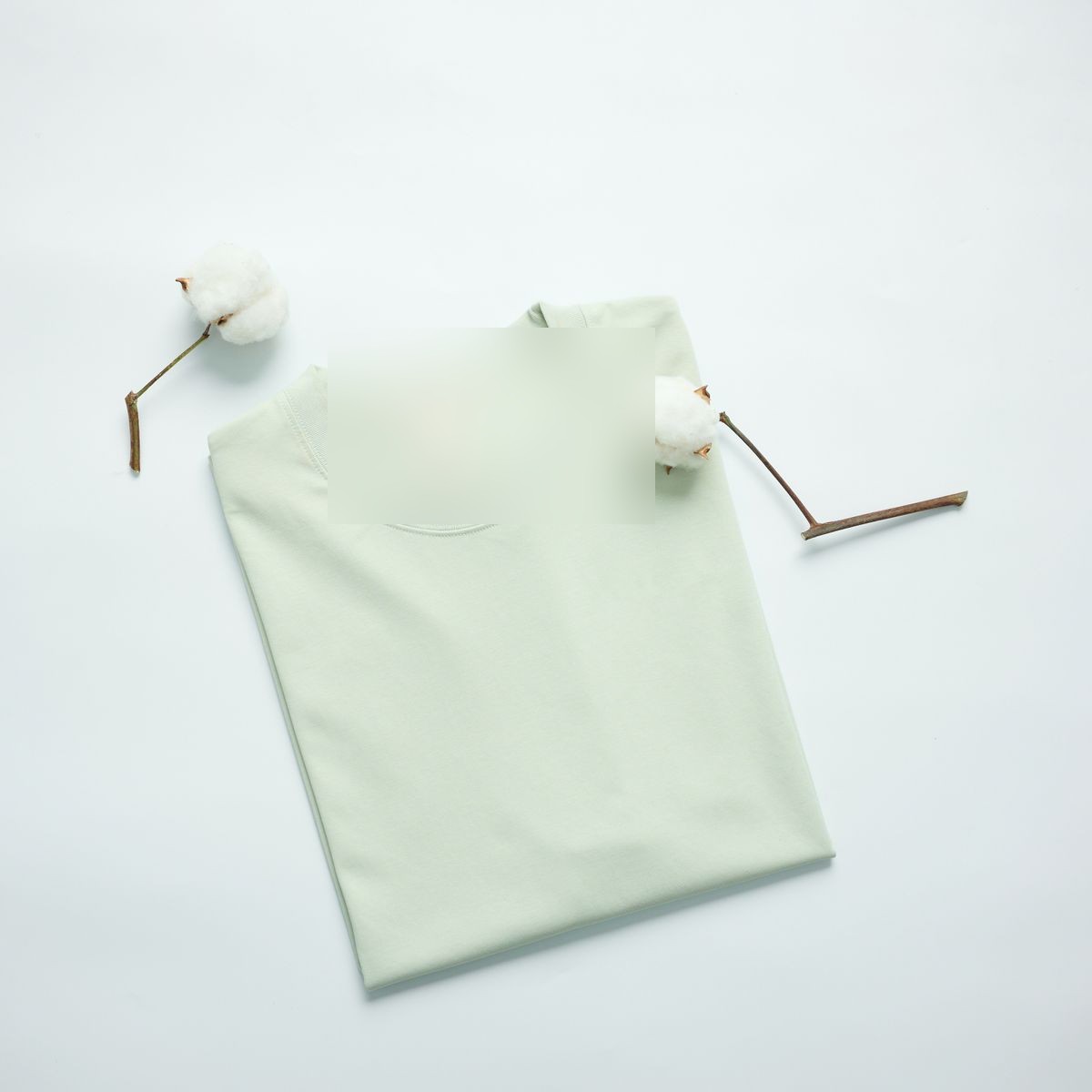 A folded mint green cotton tee